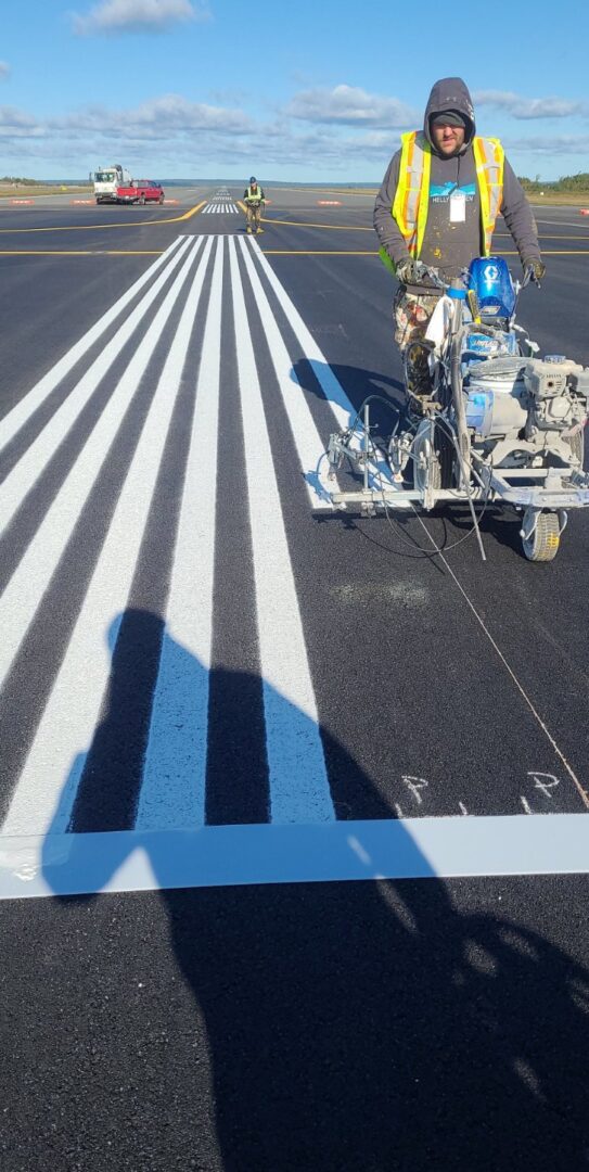 a person operating a machine for line striping