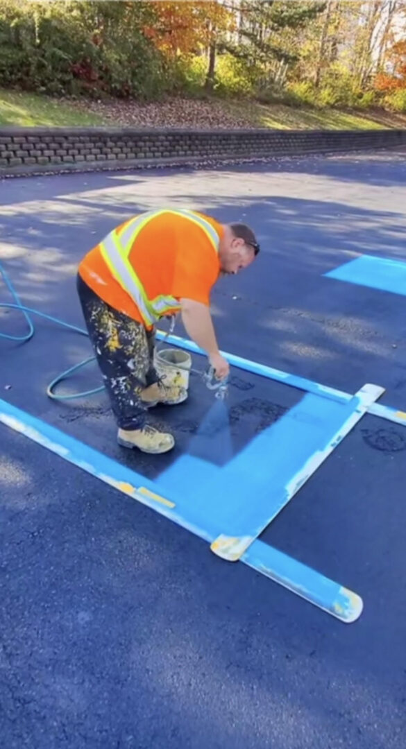 a person line striping a pavement