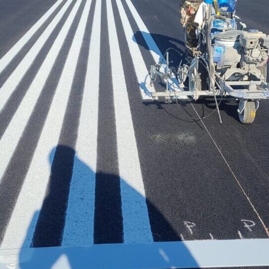 a person operating a machine for line striping