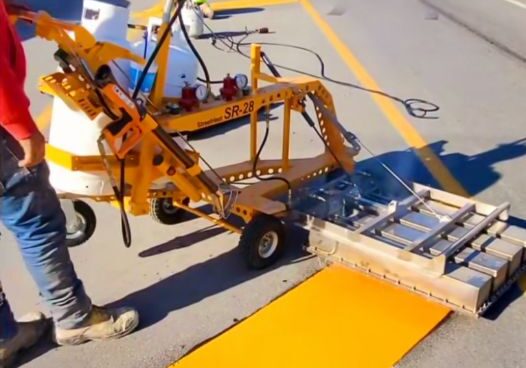 a group of people completing a line striping road project